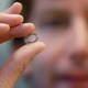 Brian Otis, Google X project lead, holds a contact lens Google was testing to explore tear glucose in 2014.